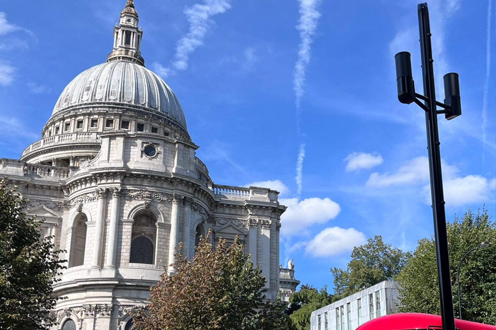 London landscape with red London bus and EE tower.